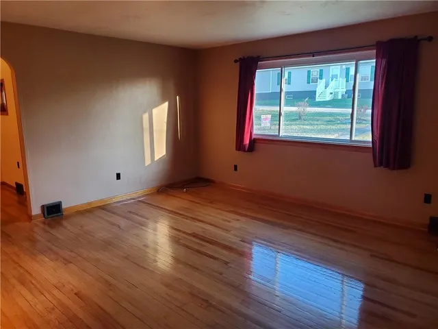 a view of a room with wooden floor and cabinet