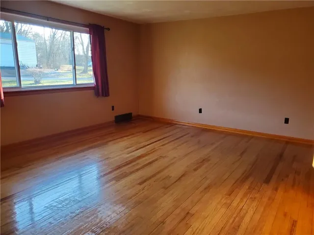 a view of a room with wooden floor and closet