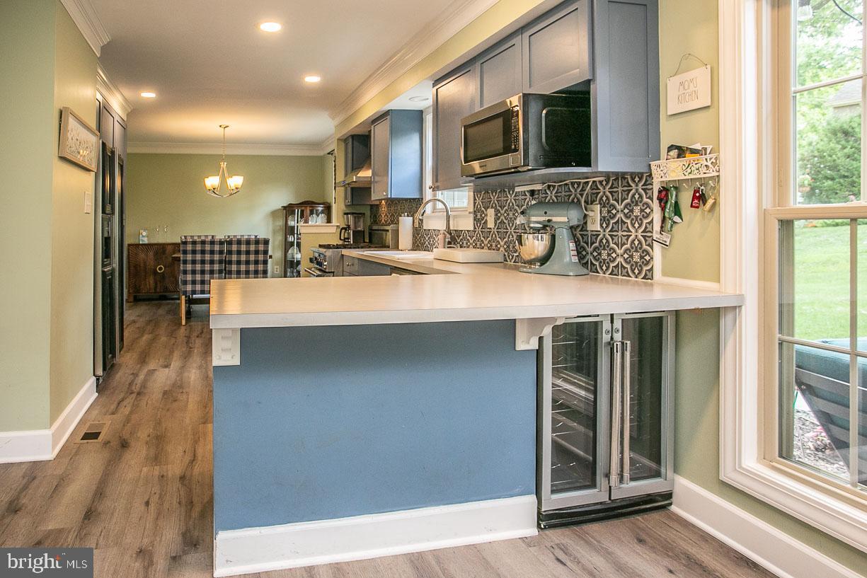 295 Sugartown Road Wayne, PA 19087 - Photo 12 of 36 a kitchen with stainless steel appliances sink a microwave and cabinets