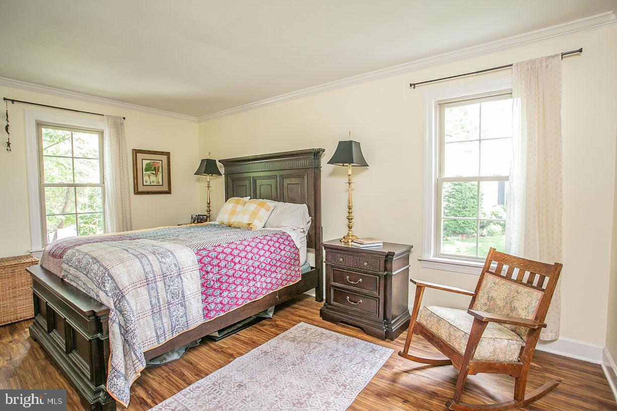 295 Sugartown Road Wayne, PA 19087 - Photo 20 of 36 a bedroom with a bed chair and two windows