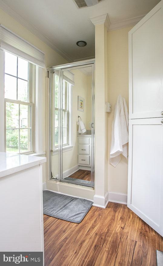 295 Sugartown Road Wayne, PA 19087 - Photo 21 of 36 a view of an empty room with wooden floor and a window