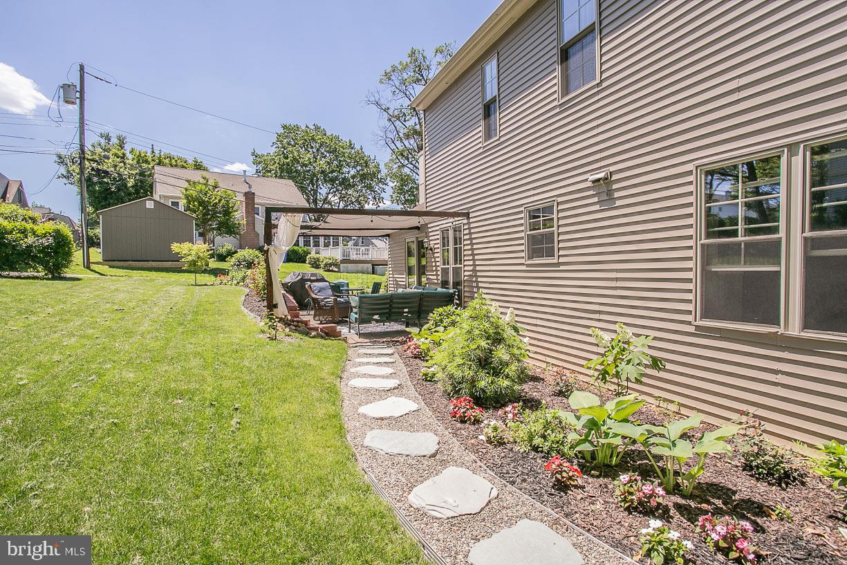 295 Sugartown Road Wayne, PA 19087 - Photo 29 of 36 a view of a backyard with plants and a patio