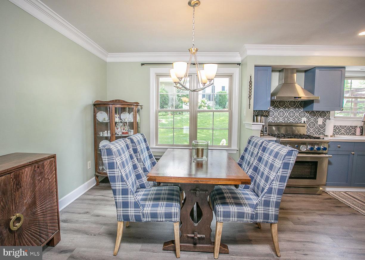 295 Sugartown Road Wayne, PA 19087 - Photo 8 of 36 a dining room with furniture a chandelier and wooden floor