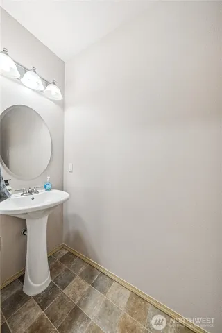 a bathroom with a sink and mirror