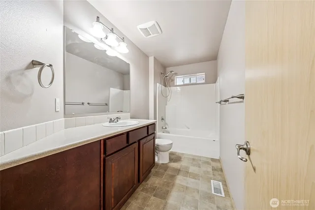 a bathroom with a double vanity sink mirror and shower