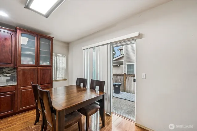 a view of a dining room with furniture window and wooden floor