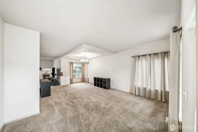 an empty room with closet and windows