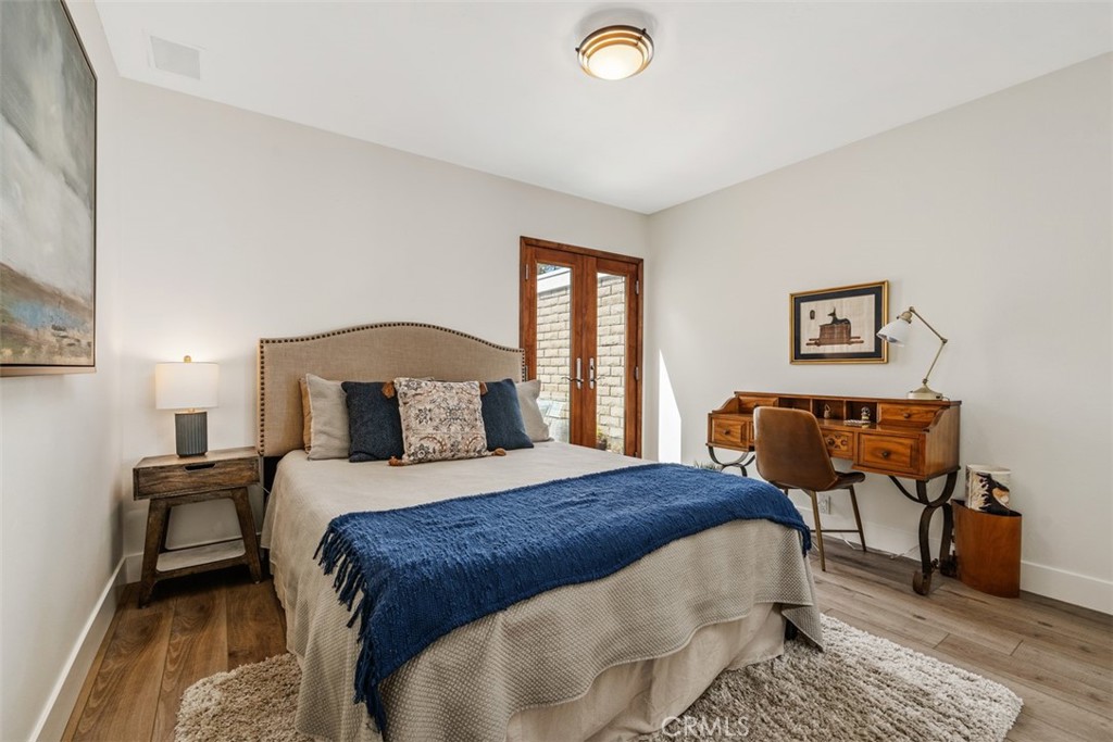 23862 Marmara Bay Dana Point, CA 92629 - Photo 16 of 21 a bedroom with a bed and wooden floor