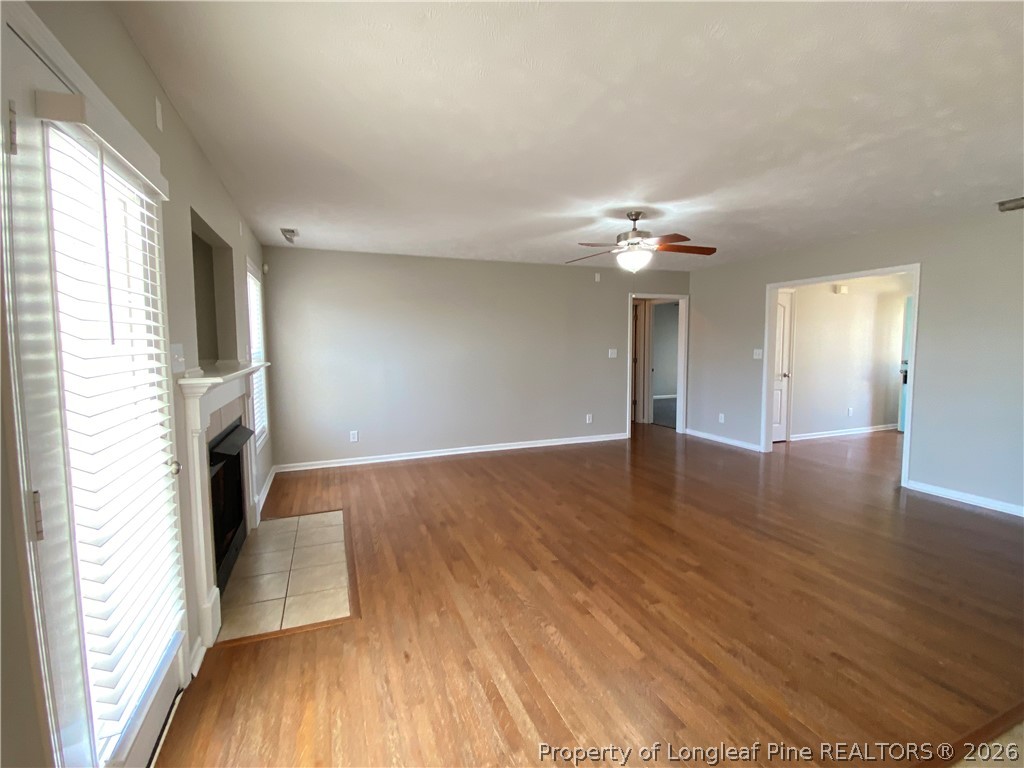 58 Polk Street Spring Lake, NC 28390 - Photo 12 of 26 a view of an empty room with wooden floor and a window