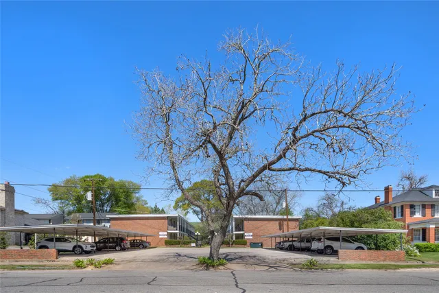a front view of a building with tree s