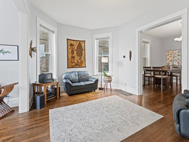 a living room with furniture wooden floor and a table
