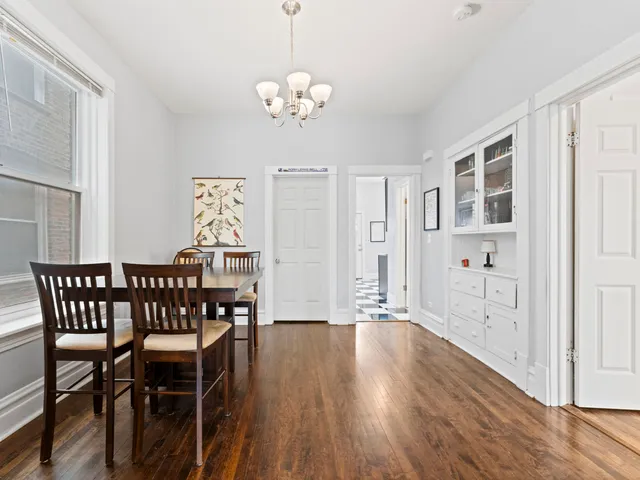 a view of a dining room with furniture wooden floor and chandelier
