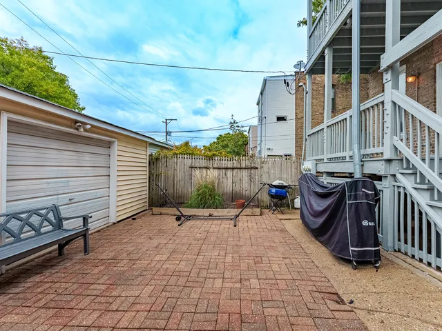 a view of a patio with table and chairs with wooden fence and plants