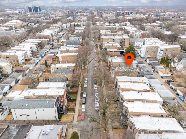 an aerial view of residential houses with city view