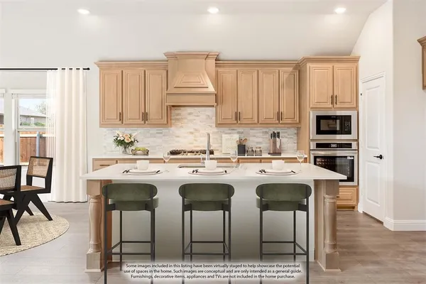 a kitchen with kitchen island granite countertop a stove a sink a dining table and chairs