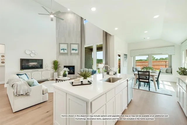 a living room with furniture and a dining table with kitchen view