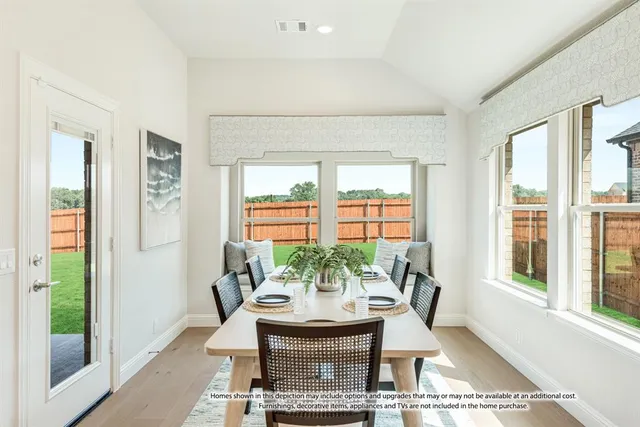 a view of a dining room with furniture and a window