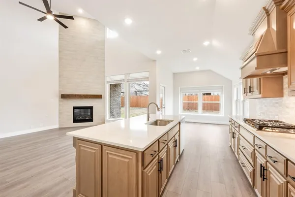 a kitchen with granite countertop a sink stove and cabinets