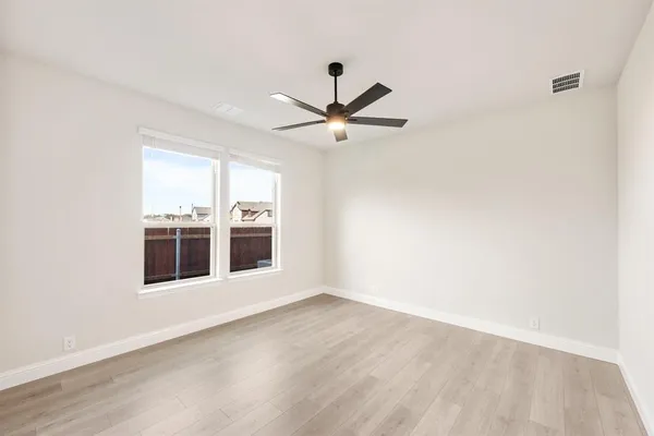 a living room with stainless steel appliances a wooden floor