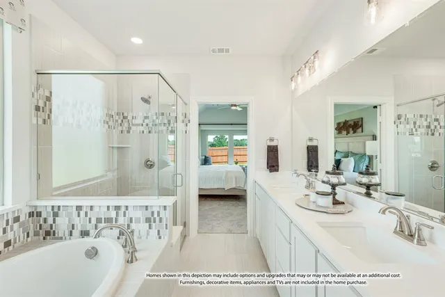 a en suite bathroom with a tub sink and mirror