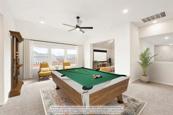 a room with pool table and windows