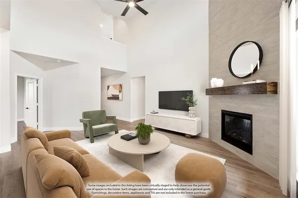 a living room with furniture a flat screen tv and a fireplace