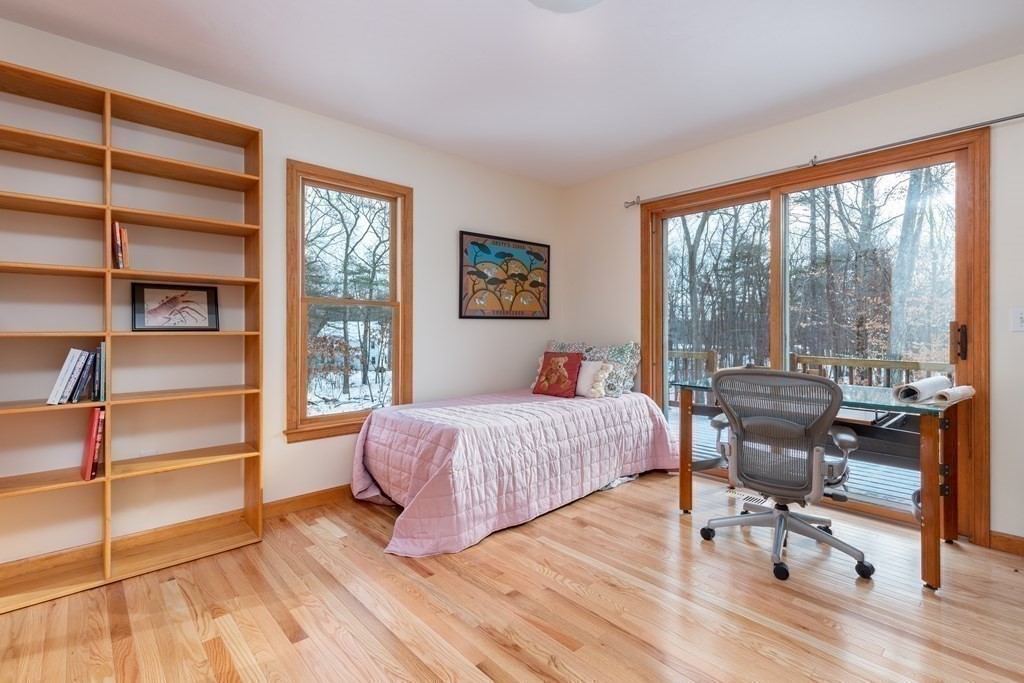 82 Nashoba Road Littleton, MA 01460 - Photo 11 of 39 a bedroom with a bed and large windows