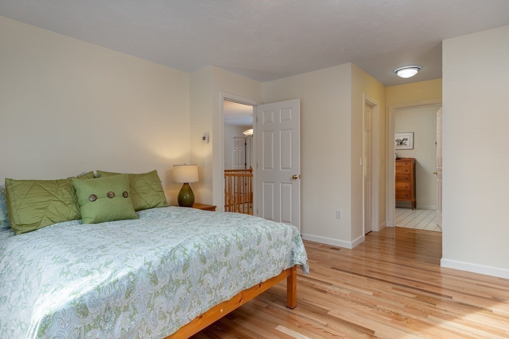 82 Nashoba Road Littleton, MA 01460 - Photo 17 of 39 a bedroom with a bed and wooden floor