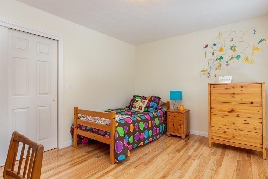 82 Nashoba Road Littleton, MA 01460 - Photo 20 of 39 a bedroom with a bed and wooden floor