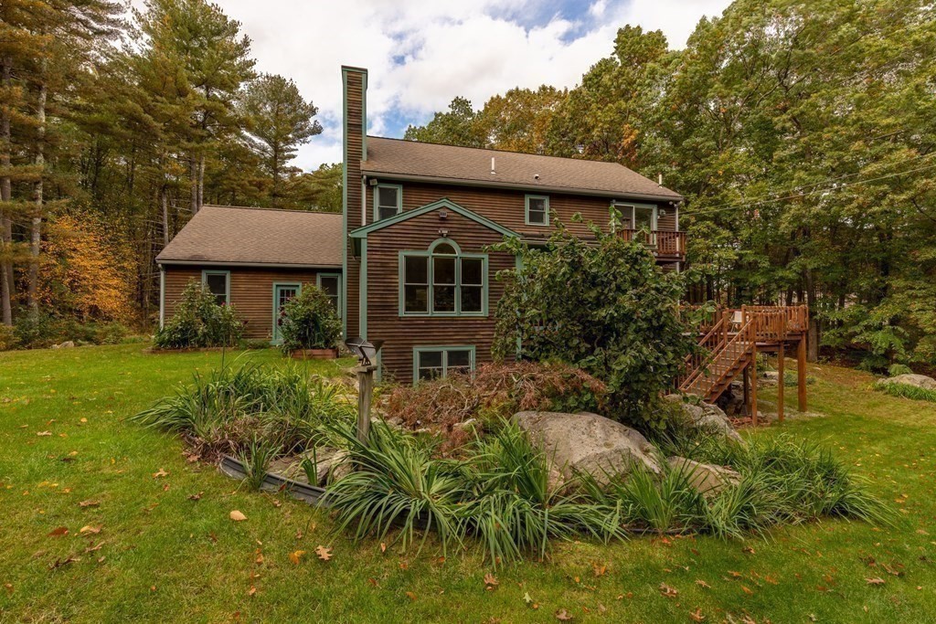 82 Nashoba Road Littleton, MA 01460 - Photo 27 of 39 a front view of a house with a yard