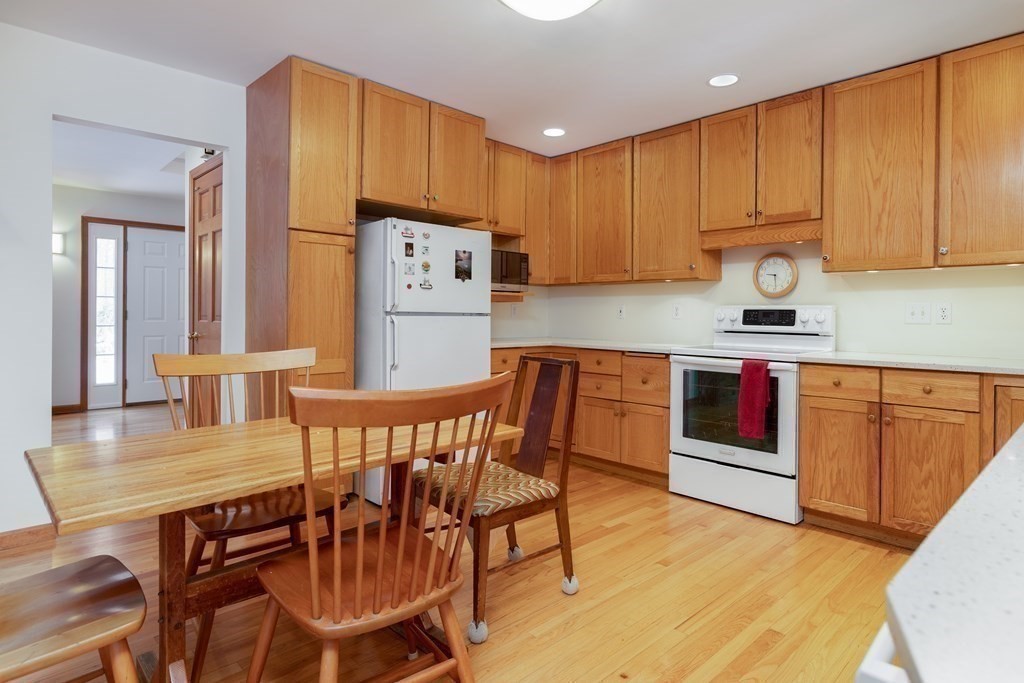 82 Nashoba Road Littleton, MA 01460 - Photo 5 of 39 a kitchen with granite countertop a dining table chairs and granite counter tops