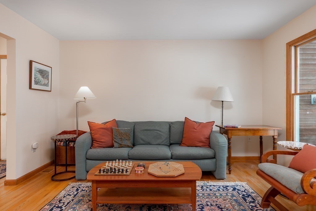 82 Nashoba Road Littleton, MA 01460 - Photo 10 of 39 a blue couch sitting on top of a table