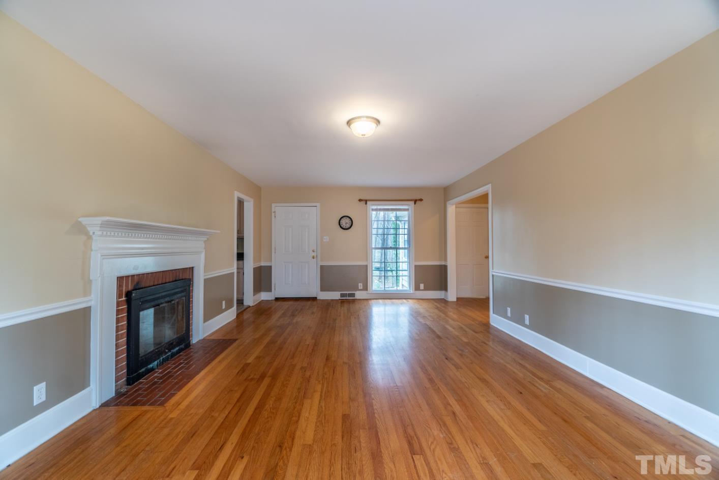 2 Maple Drive Chapel Hill, NC 27514 - Photo 25 of 57 an empty room with wooden floor fireplace and windows