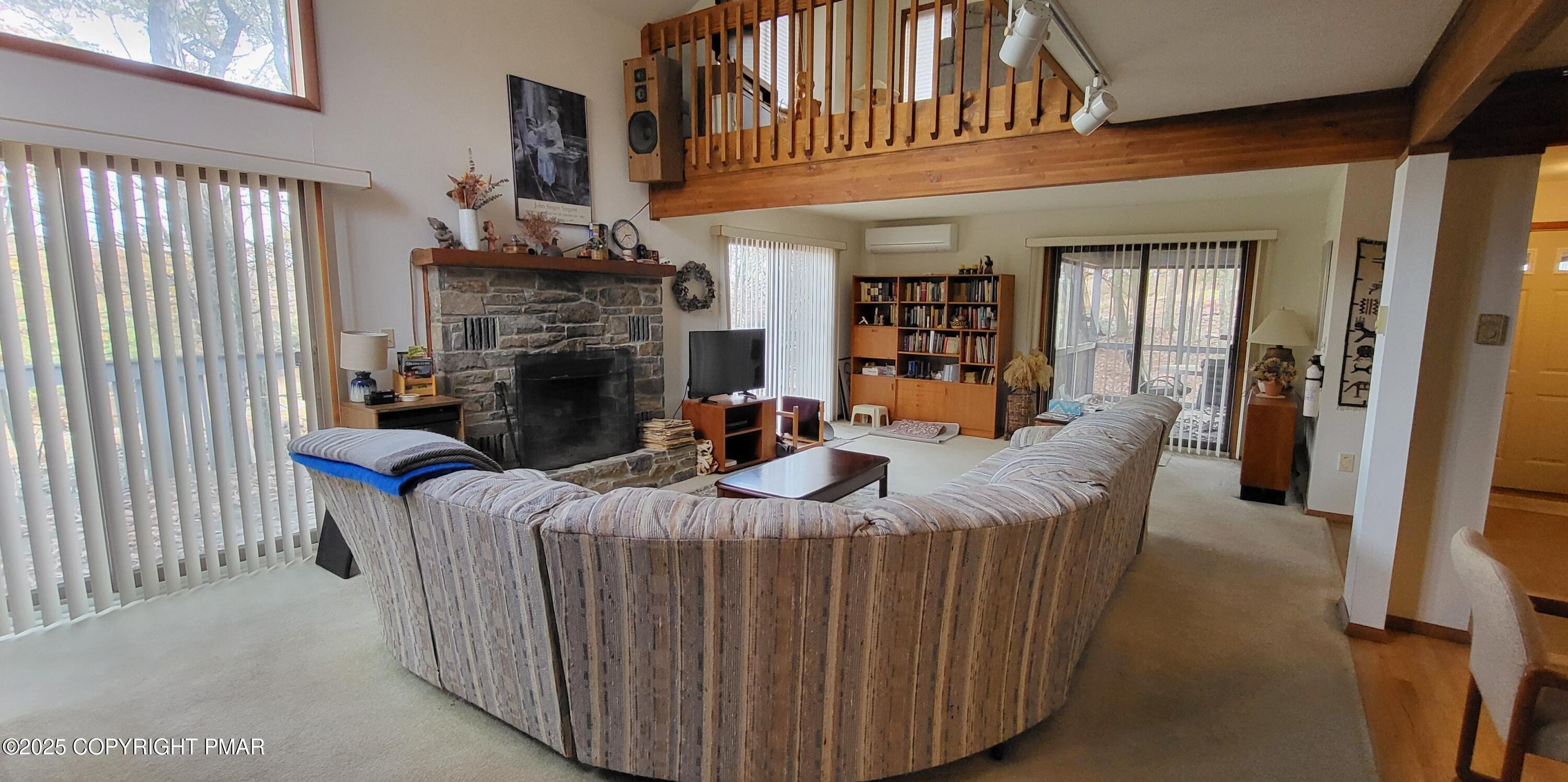 130 Bellingham Drive Bushkill, PA 18324 - Photo 13 of 65 a living room with furniture a fireplace and a large window