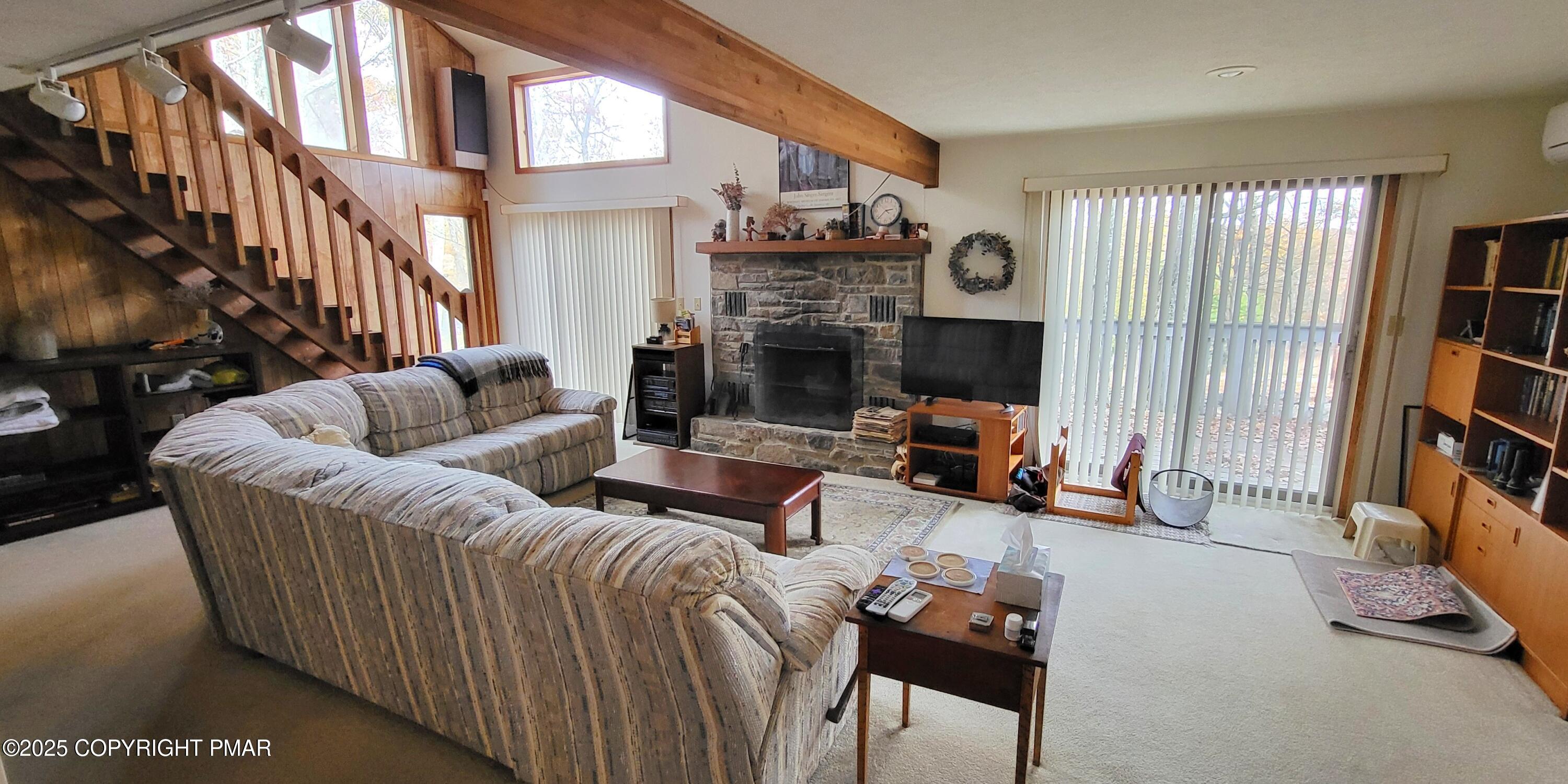 130 Bellingham Drive Bushkill, PA 18324 - Photo 13 of 65 a living room with furniture a fireplace and a large window