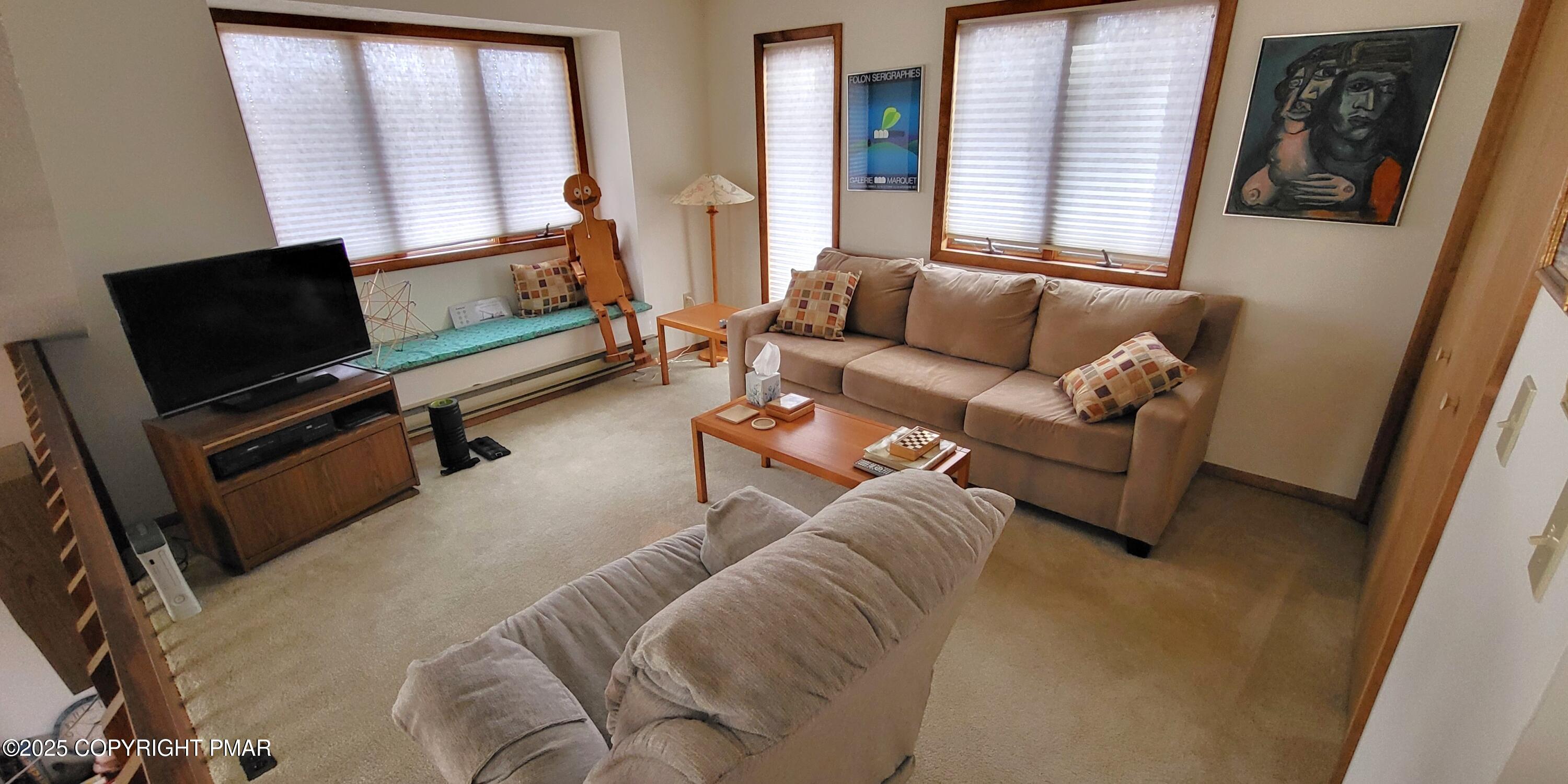 130 Bellingham Drive Bushkill, PA 18324 - Photo 26 of 65 a living room with furniture and a flat screen tv