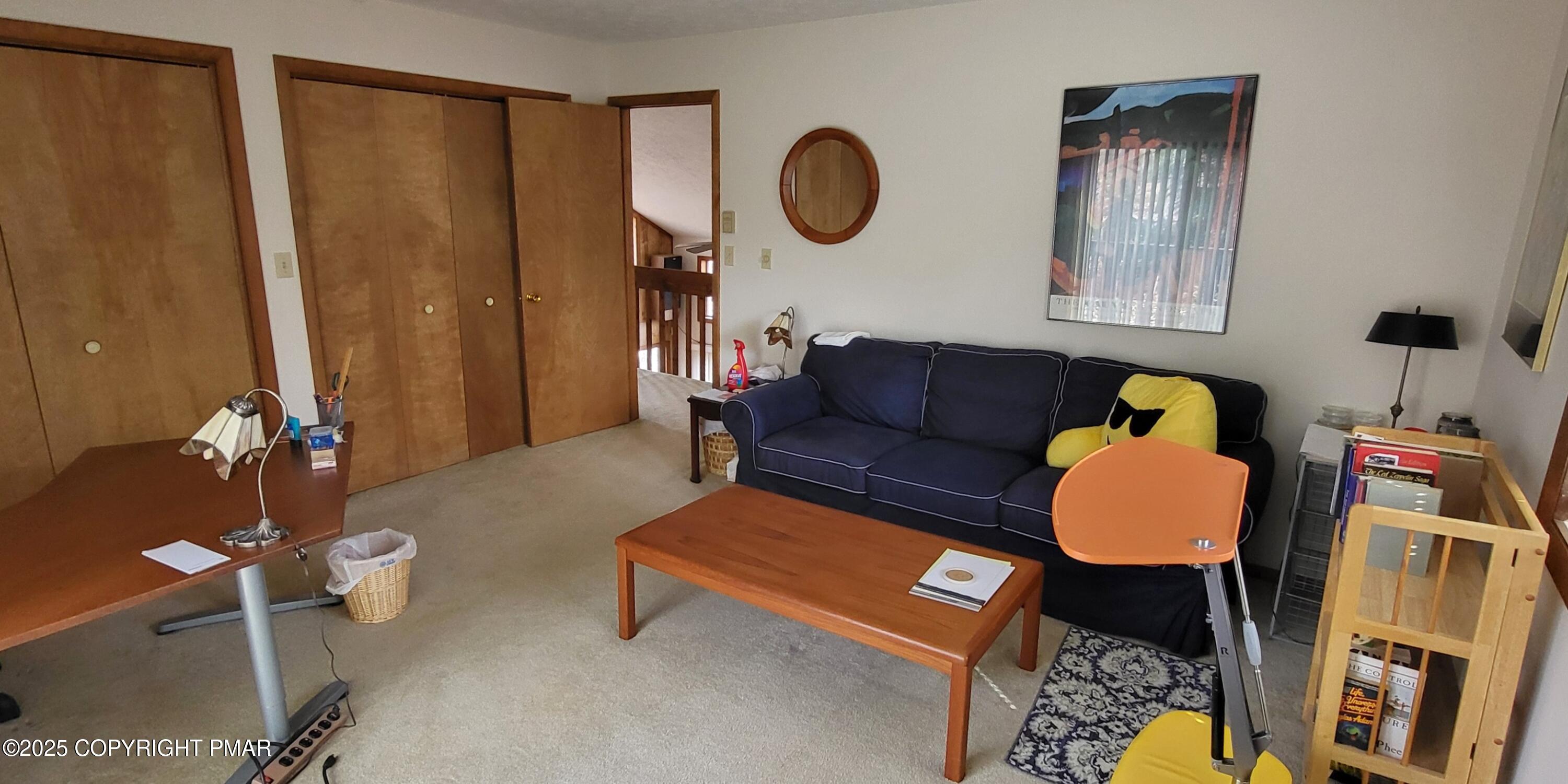 130 Bellingham Drive Bushkill, PA 18324 - Photo 30 of 65 a living room with furniture and a mirror