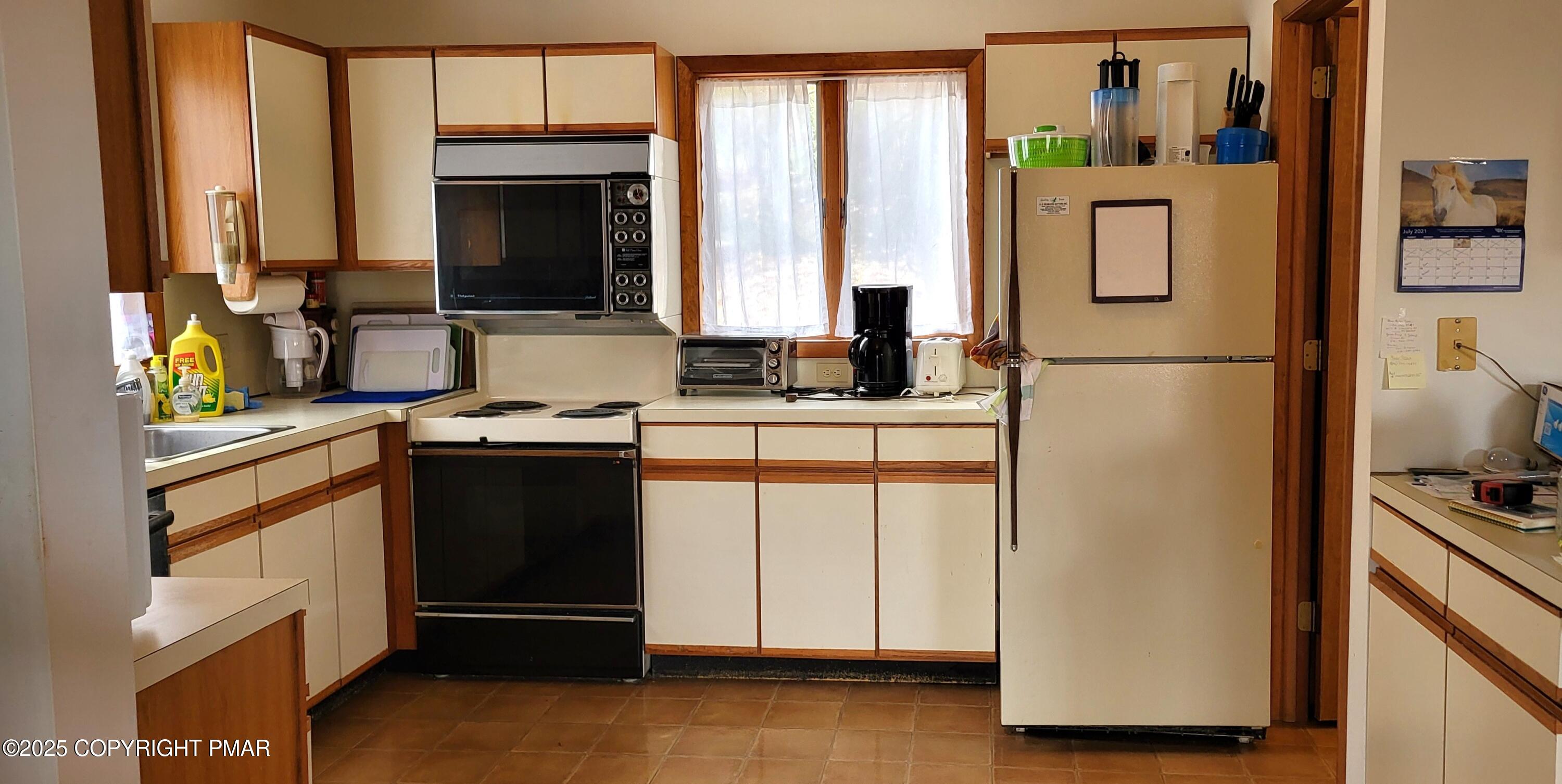 130 Bellingham Drive Bushkill, PA 18324 - Photo 5 of 65 a kitchen with stainless steel appliances a refrigerator sink and cabinets