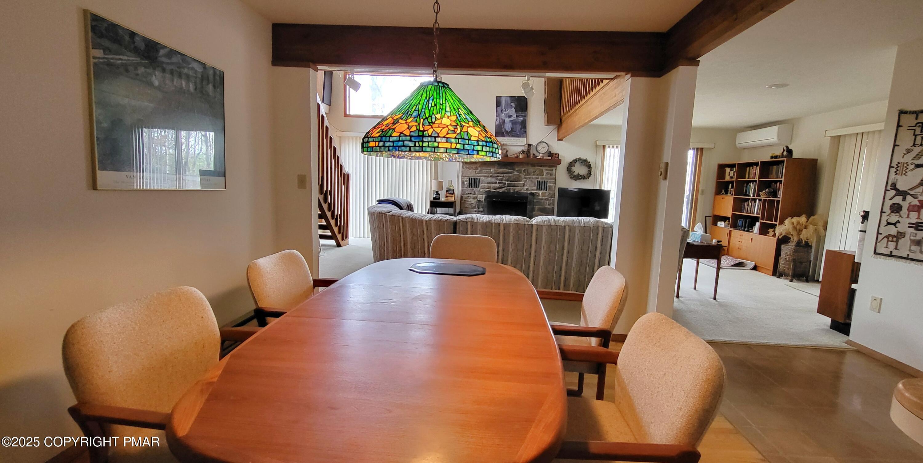 130 Bellingham Drive Bushkill, PA 18324 - Photo 7 of 65 a view of a dining room with furniture a chandelier and wooden floor