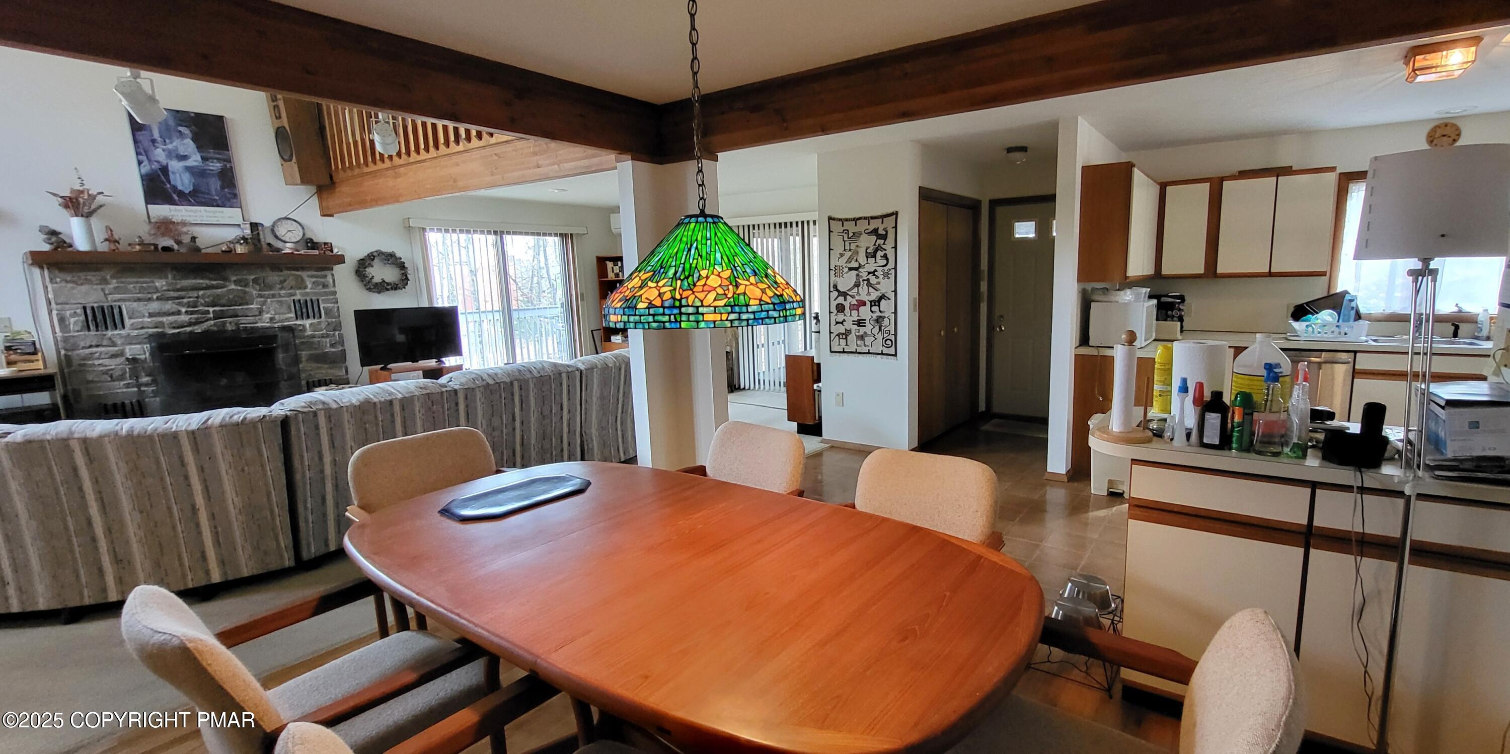 130 Bellingham Drive Bushkill, PA 18324 - Photo 7 of 65 a view of a dining room with furniture a chandelier and wooden floor