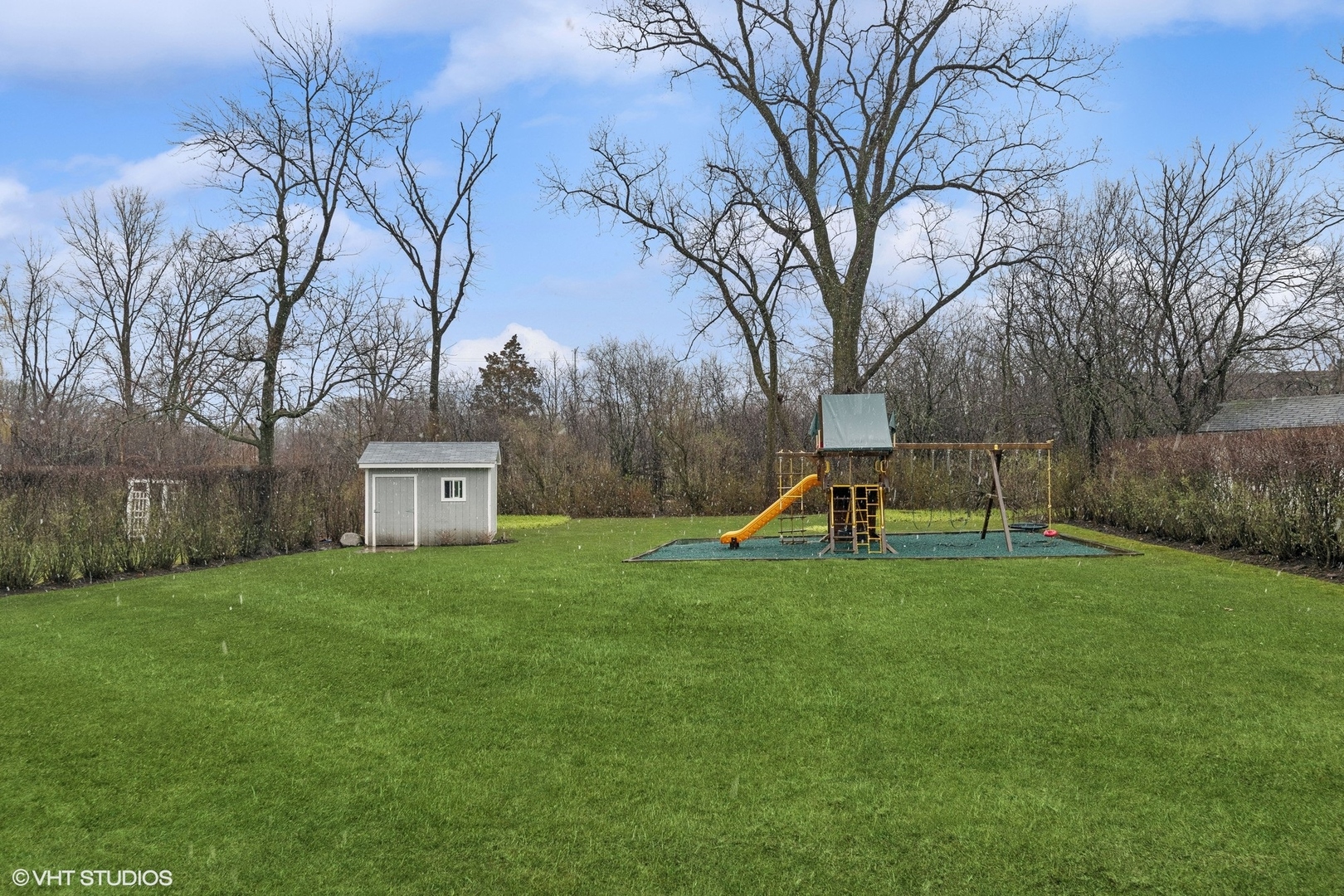 87 Ridge Road Highland Park, IL 60035 - Photo 23 of 27 a view of a garden with a slide and a tree