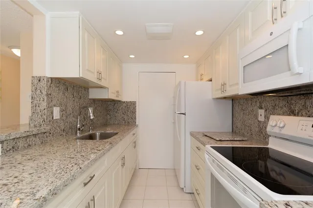 a kitchen with a sink cabinets and stainless steel appliances