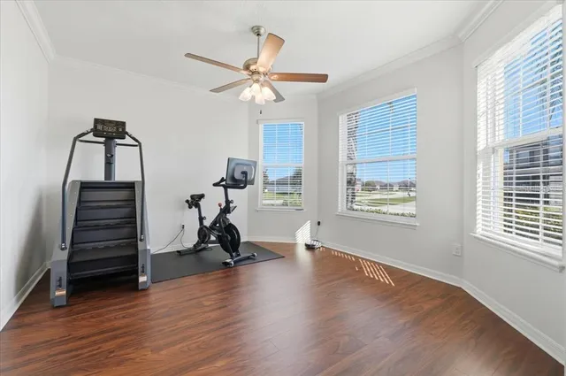 a view of room with wooden floor fan and windows