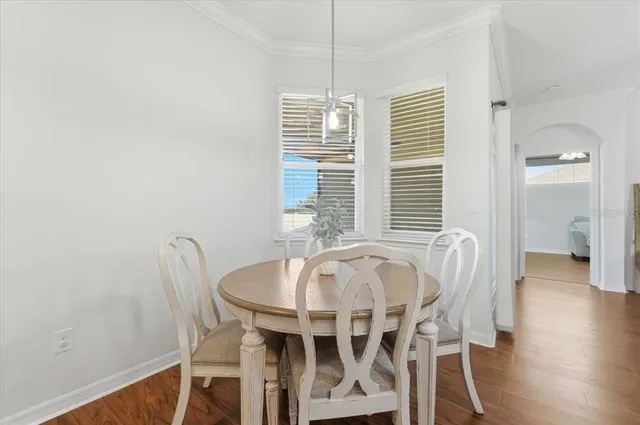 a view of a dining room with furniture and wooden floor
