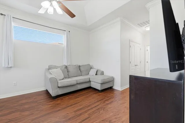 a bedroom with furniture and wooden floor