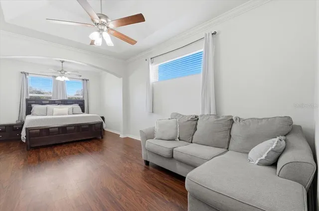 a bedroom with a bed and a chandelier