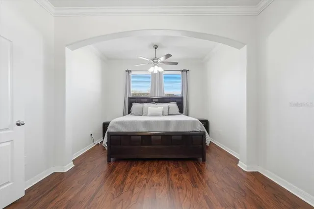 a bedroom with bed and a chandelier