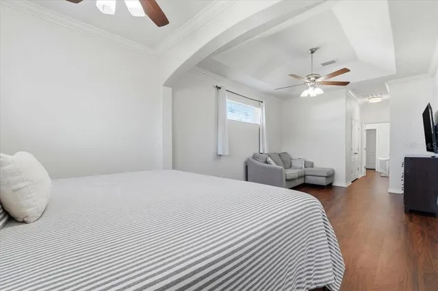 a spacious bedroom with a bed and a couch