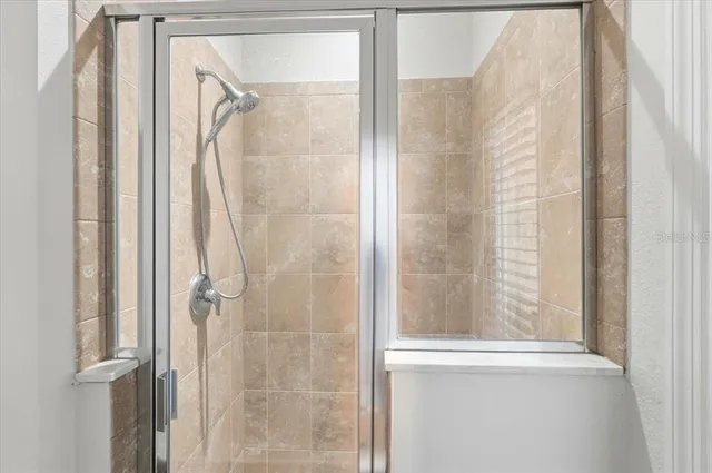 a view of walk in closet with wooden floor