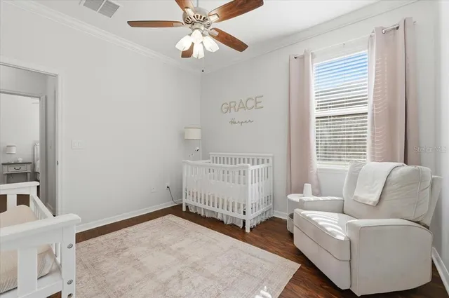 a bedroom with a large bed and a chandelier